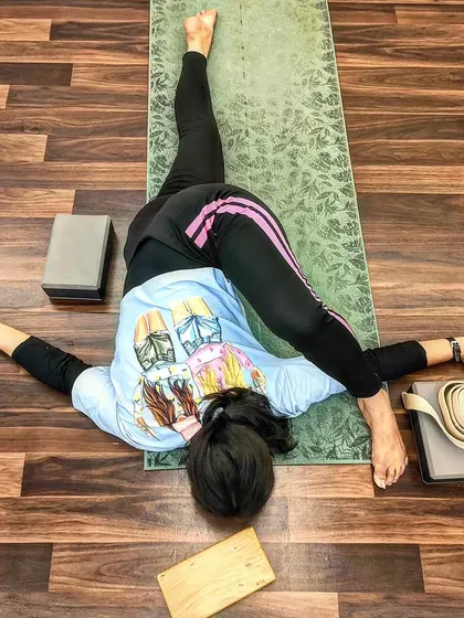 An overhead view of a twisting split variation, showcasing full-body flexibility.