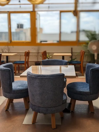 This table for four is reserved for memories and conversations. The simple, modern design and comfortable chairs make it an ideal spot for catching up with friends.