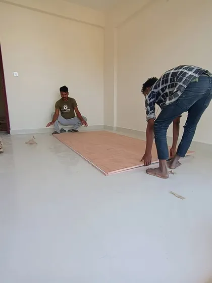Precision is key in our work. Here, our carpenters are laying down plywood flooring sheets, ensuring a perfect foundation for the wooden flooring that will be installed in this bedroom.