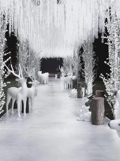We craft magical celebrations for every milestone. This 'Winter Wonderland' first birthday party featured an enchanting entrance with a forest of white trees and arctic animals, creating a whimsical and immersive experience for the youngest of guests and their families.