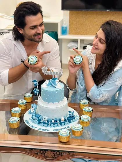 Welcoming baby Ruhaan home with a custom cake and cupcake set for Dipika and Shoaib. The two-tier cake features a choo-choo train and adorable teddy bears.