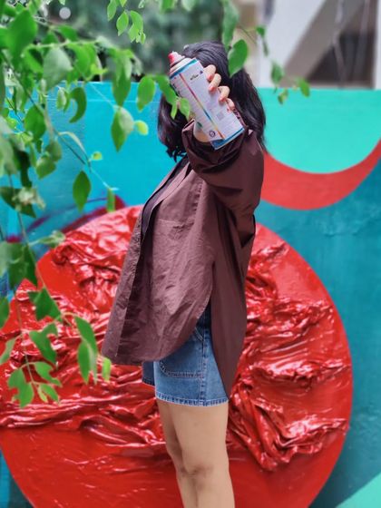 Another shot from the 'Reclaiming Red' series, showing me with a spray can, ready to add another layer of color.