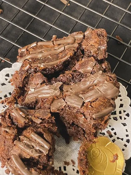 A close-up of our decadent brownie pieces, showing the rich texture and generous chocolate chunks inside.