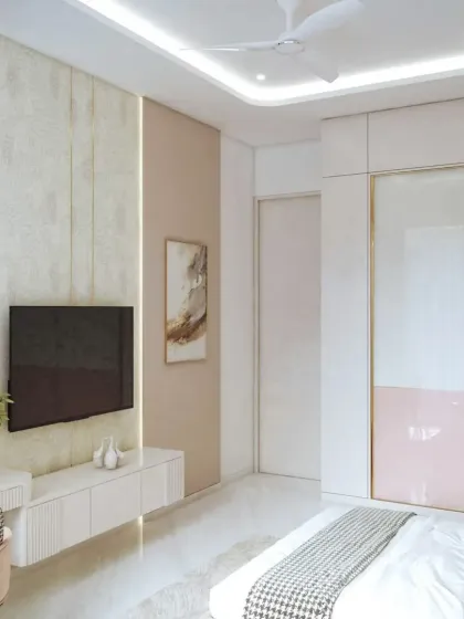 This is the TV and wardrobe view of the blush-toned bedroom. The sliding wardrobe doors feature a two-tone design with gold accents, matching the room's modern and luxurious theme.