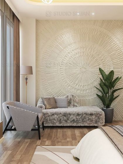 A cozy seating corner in the bedroom, featuring a unique textured wall art piece that serves as a stunning focal point. The plush chaise lounge invites relaxation.