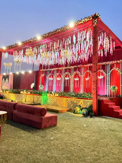 A beautiful red-themed stage with a canopy of hanging white and red floral strings, creating a delicate and romantic overhead-display.