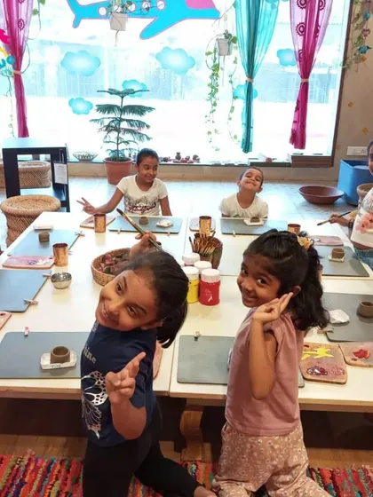 A group of girls posing happily during their art playdate. Friendships blossom over shared creative projects.