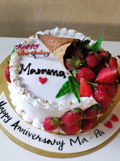A beautiful strawberry-themed cake with an overflowing cone of fresh berries. A perfect cake for a "berry" special anniversary or birthday.