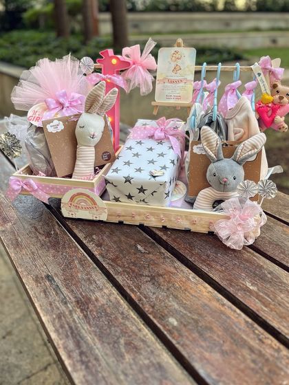 This angle shows the scale and thoughtful arrangement of the entire hanger hamper, designed to be a stunning centerpiece for a baby arrival celebration.