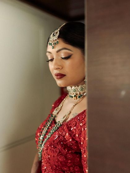 A peek from the doorway. Kavi's bold lip and defined eyes create a look of drama and elegance.
