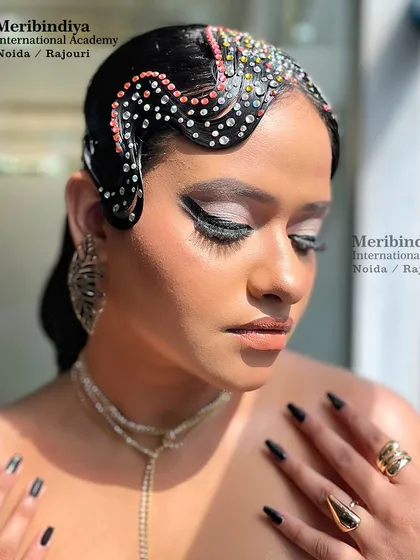 A beautifully lit shot of the creative makeup look, highlighting the glowing skin and the contrast between the dark makeup and sparkling hair accessories.