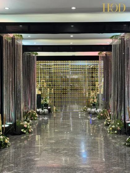 A head-on view of the crystal and gold grid backdrop at the end of the entrance tunnel, creating a sense of destination and glamour.