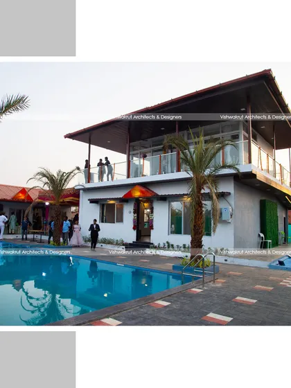 The completed villa during an evening event. This photo shows how the space comes alive, with the upper balcony providing a great vantage point over the pool area.
