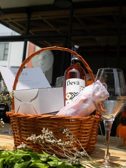 A beautifully arranged picnic basket for one of our guests, complete with a bottle of rosé wine and gourmet treats.