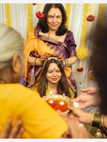 A touching moment from a Haldi ceremony, as a mother blesses the bride during the traditional ritual.