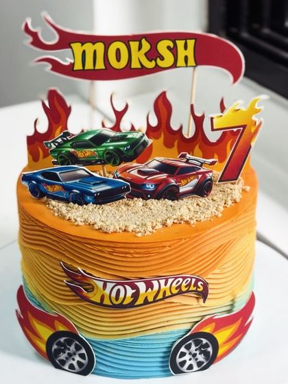 Turning up the heat for birthday number seven! This Hot Wheels inspired cake is all about speed and excitement, with a fiery design and cool car toppers for a little racer.