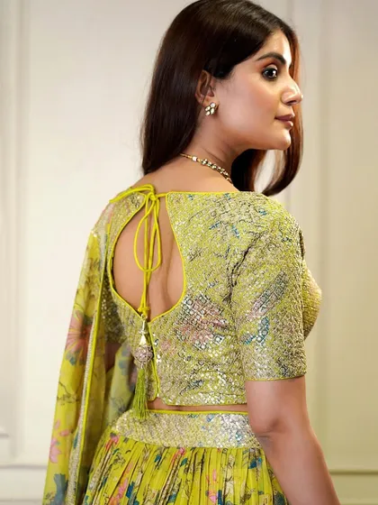 The perfect Haldi outfit. This yellow organza lehenga is bright, cheerful, and adorned with sequins to make you shine on your special day.