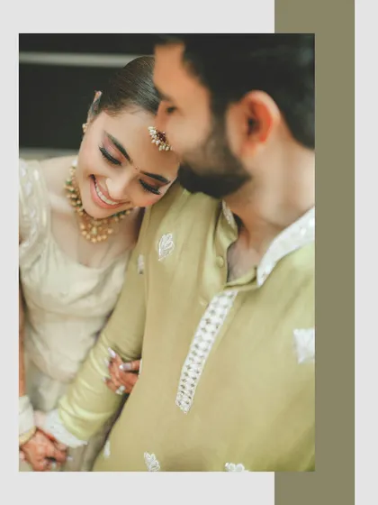 An intimate close-up capturing a quiet moment of affection. The bride's gentle smile as she rests on her partner's shoulder highlights our focus on capturing the deep, emotional connection between a couple.