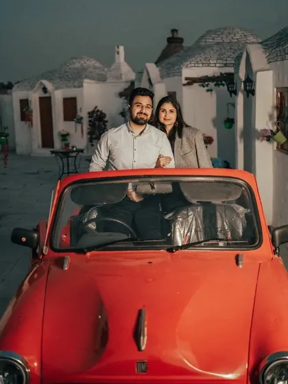 A couple enjoys a romantic evening drive in our red convertible, set against the backdrop of our Santorini-style village. This prop is versatile and works well with multiple themes.