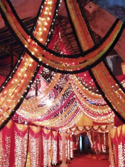 This is a grand entrance gate I decorated for a large event. I used layers of marigold garlands and bright fairy lights to build a traditional and welcoming entryway for guests arriving at the venue.
