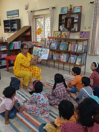 A closer view of our story session, showing the children's rapt attention. The background filled with books highlights the literary environment we nurture.