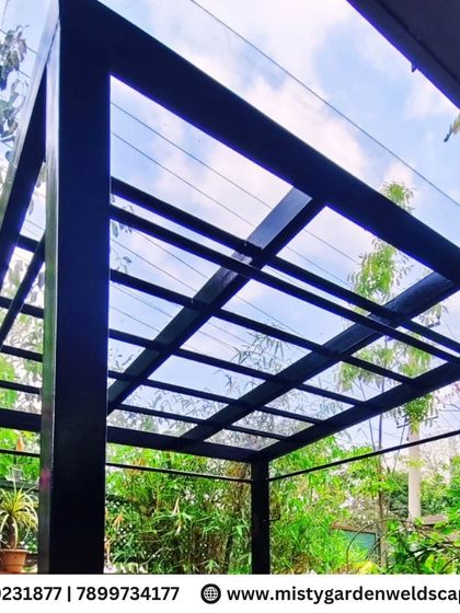 A low-angle shot of the completed compact sheet pergola, showing the clear sky through the transparent roofing. This design allows for natural light to flood the space while still providing protection from rain.