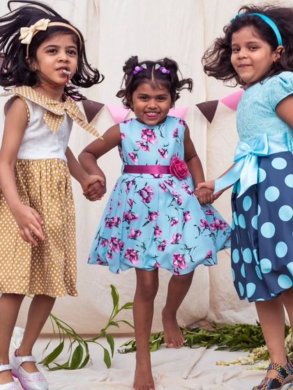 Three friends, three distinct styles. From mustard polka dots to blue florals to bold blue dots, this image celebrates individuality and friendship.