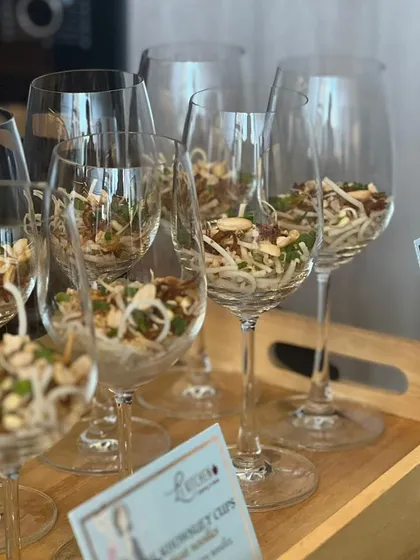 A light and healthy appetizer of gluten-free glass noodles with peanuts and fresh herbs, elegantly served in wine glasses for easy handling.