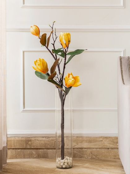 For a cheerful and sunny accent, I recommend the yellow artificial magnolia stem. It's a simple way to bring a bit of brightness and positivity into your living space.
