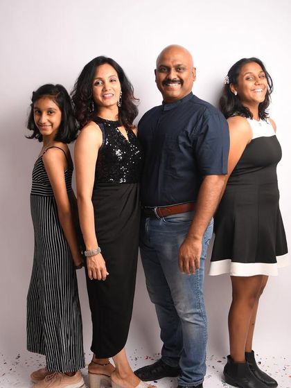 A simple and beautiful standing portrait of the whole family. Coordinated outfits can make a big impact, creating a cohesive and polished look for your family photos.