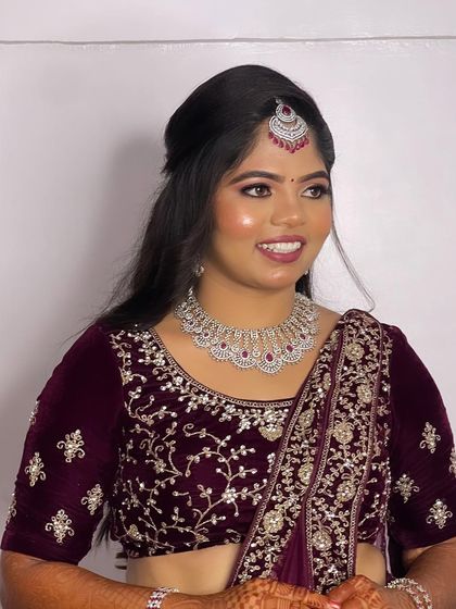 Hima's full reception look. The half-up hairstyle keeps the look modern and chic, while the intricate embroidery on her lehenga adds a touch of tradition.