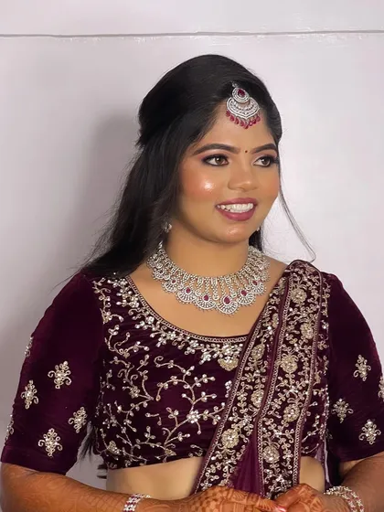 Hima's full reception look. The half-up hairstyle keeps the look modern and chic, while the intricate embroidery on her lehenga adds a touch of tradition.
