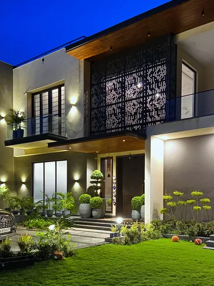 The entrance to this Sultanpur farmhouse at dusk. I used a combination of landscape lighting to illuminate the pathway, highlight the architectural features, and showcase the carefully placed bonsai trees in their large planters.