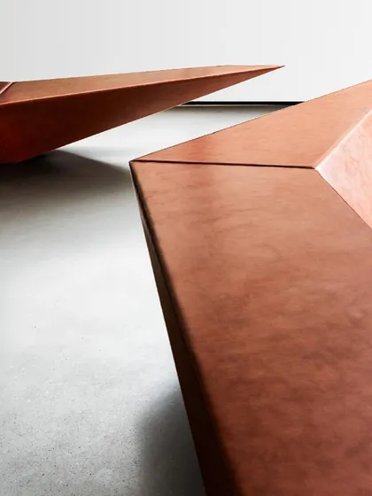 Our design principles extend across all scales. These bespoke, angular seating elements in the Parinee Lobby were designed as sculptural objects that define the space. The form and materiality reflect the same geometric language and attention to detail found in our larger architectural and product work.
