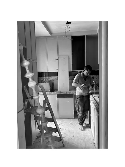 A craftsman working on the details in a kitchen. These are the moments of precision that make all the difference.
