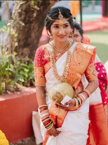 A beautiful South Indian bride with a simple and elegant updo, perfect for one of the pre-wedding ceremonies.