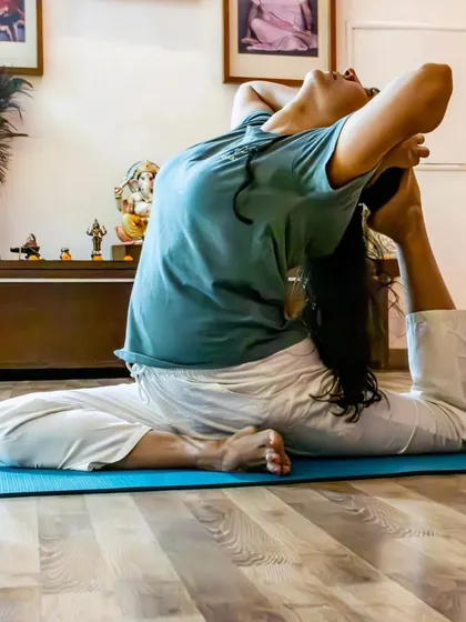 A student practices Eka Pada Rajakapotasana (One-Legged King Pigeon Pose) inside the studio. This deep posture opens the hips and chest, releasing stored tension and emotion.