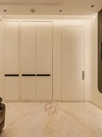 This is the ultimate entertainment zone. The space features a large projection screen on a dark stone accent wall, plush leather recliners, and a hidden mini-bar, creating a true home cinema experience.