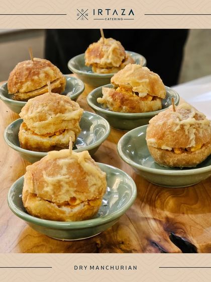 Dry Manchurian balls, a popular Indo-Chinese appetizer, served as individual portions in small bowls.