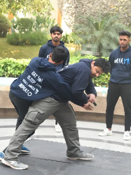 In this outdoor training scenario, we're drilling a defense against a rear grab and knife threat. This is about reacting to an ambush, creating space, and addressing the weapon as the primary threat.