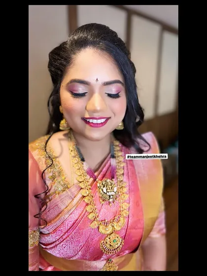 For her sister's reception, we opted for a soft glam look. I used shimmery pink eyeshadow and a matching pink lip to go with her silk saree, and styled her hair in loose curls for a romantic finish.