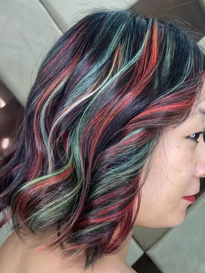 A creative multi-tonal look with streaks of red, green, and blonde. This is for the client who isn't afraid to play with color and wants a truly artistic hairstyle.