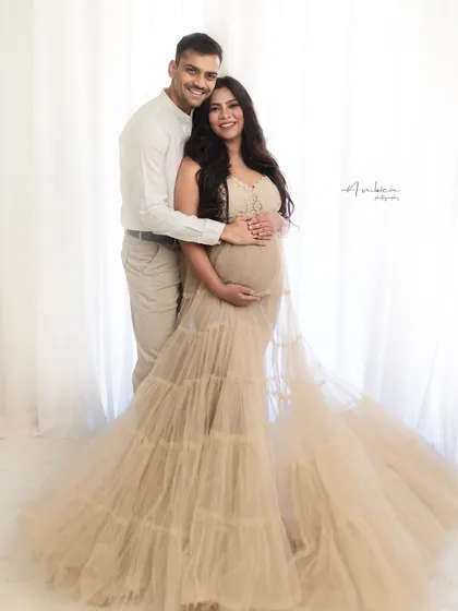 A classic couple's portrait from the angel wing session. The coordinated neutral outfits and their happy smiles create a warm and harmonious image.