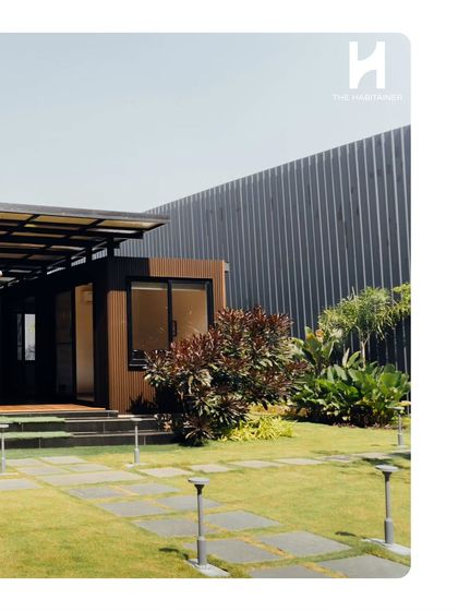 A wide view of the twin container office, showing the landscaped pathway leading to the entrance. We handle the entire project, including site development, to create a turnkey commercial space.