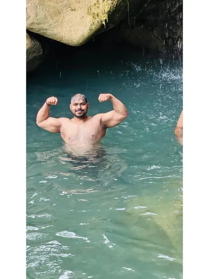 A happy moment, flexing in the water near a waterfall in the hills of Uttarakhand.