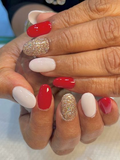 Merry and bright, just like these Christmas nails. This festive set combines classic red, clean white, and a sparkling gold glitter for a cheerful holiday manicure.