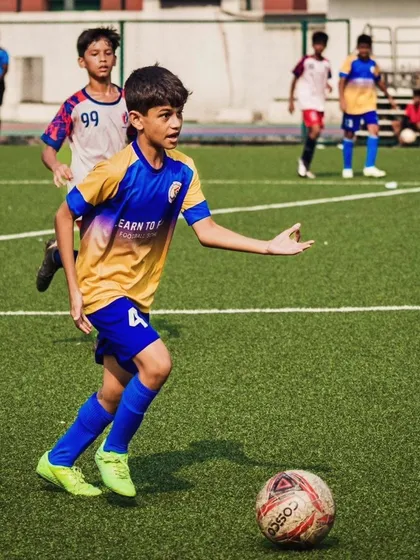 A player from our U13 team confidently carrying the ball forward in the quarterfinal match.