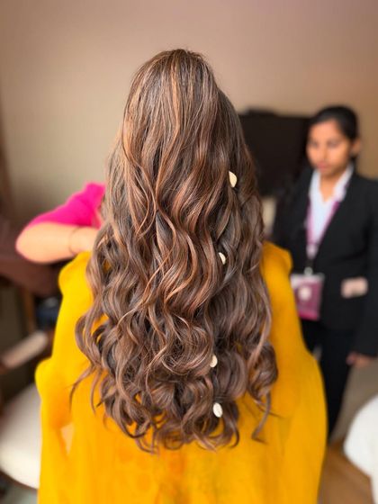 This half-ponytail with soft waves and caramel highlights is perfect for a fun, carnival-themed event. I added a few shell-like accessories for a beachy vibe.