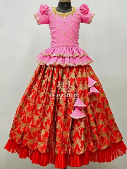 A stunning red and pink Banarasi lehenga with a tiered peplum blouse and a layered skirt for extra volume.