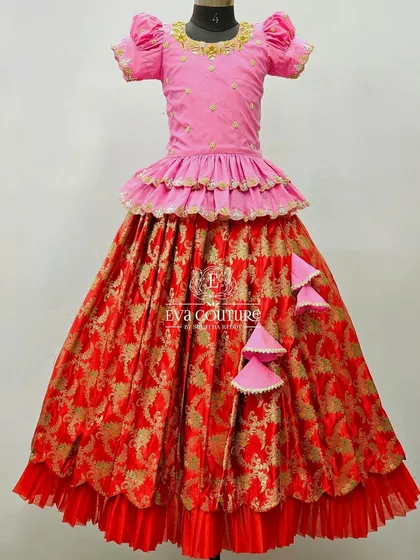 A stunning red and pink Banarasi lehenga with a tiered peplum blouse and a layered skirt for extra volume.